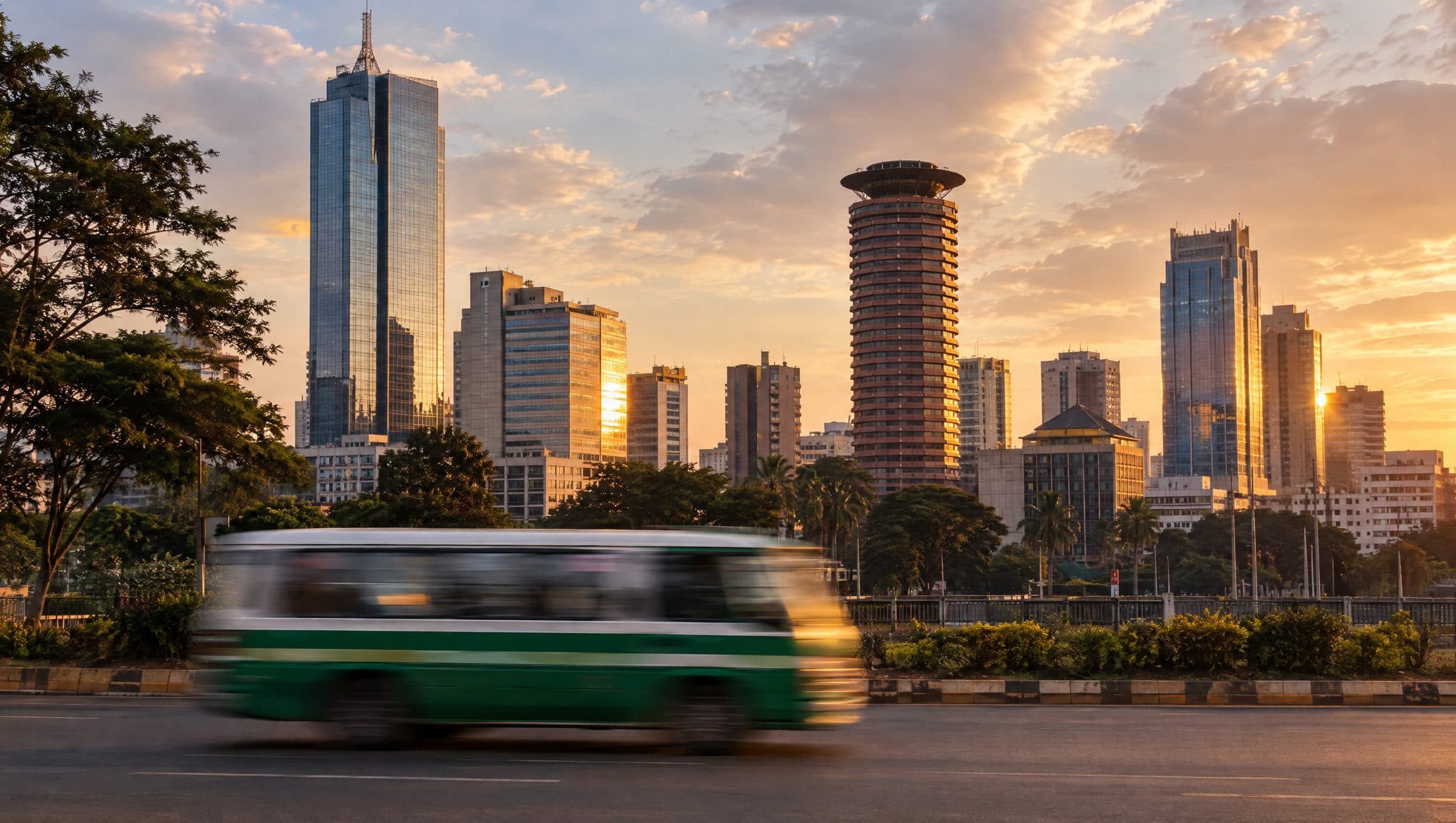 Nairobi towers at golden hour with a matatu streaking past