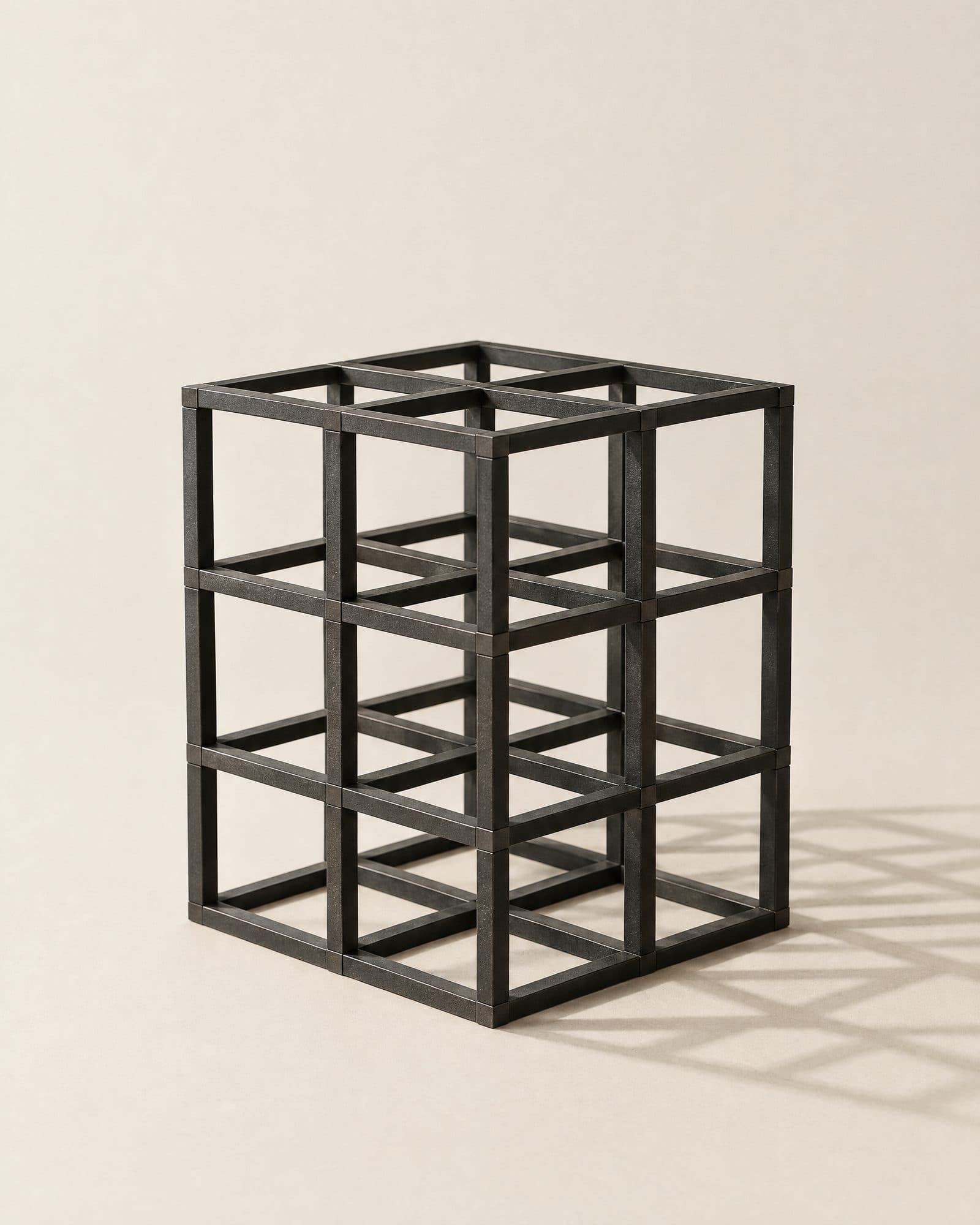 An open lattice of black steel bars forming a grid of cubes